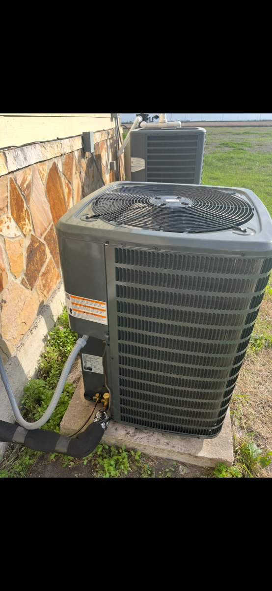 Albert DeLeon servicing an outdoor AC condenser
